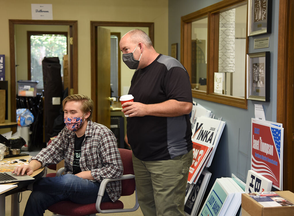 Adrian Plank, right, asks Luke Davis, Judy Baker's field director, a question Saturday in Columbia.